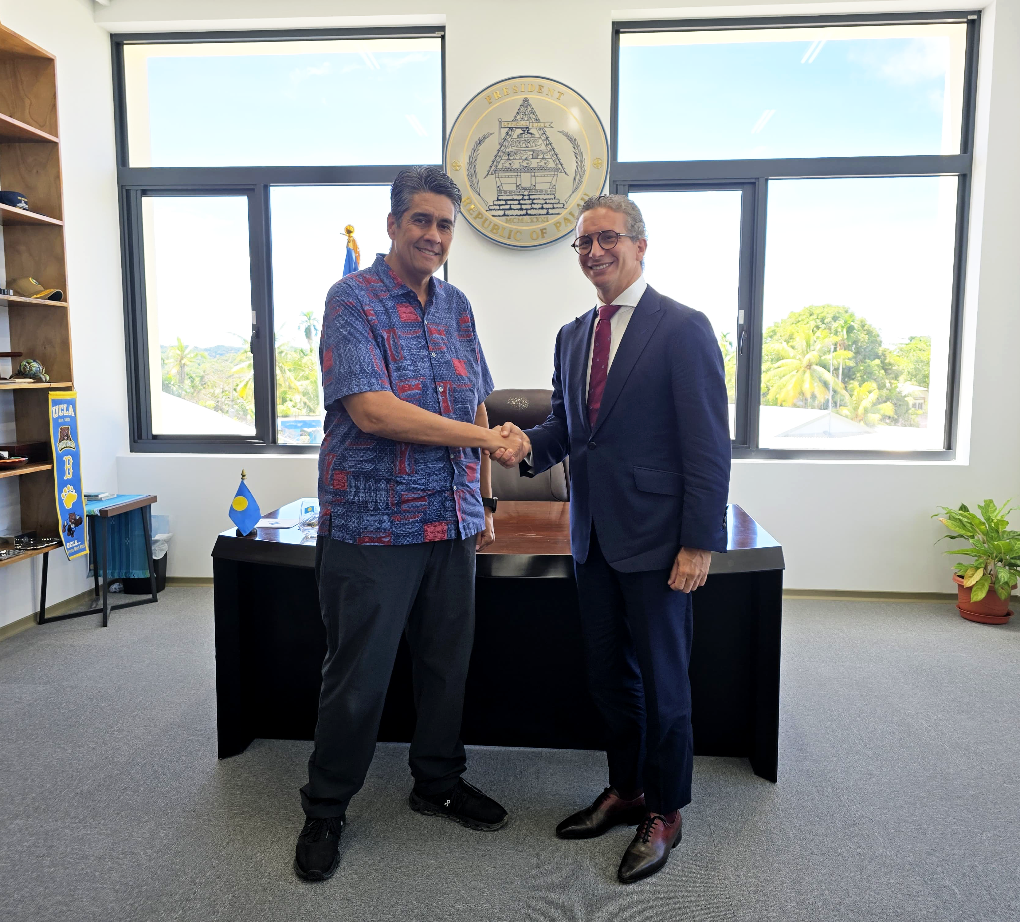 President Surangel S. Whipps Jr. and Professor Kamal Amakrane of the Global Centre for Climate Mobility seal their new partnership with a handshake in the President’s Koror office on 15 May 2025.