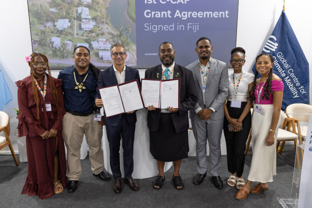 Fiji and GCCM representatives signing the first Communities Climate Adaptation Facility grant at COP30.